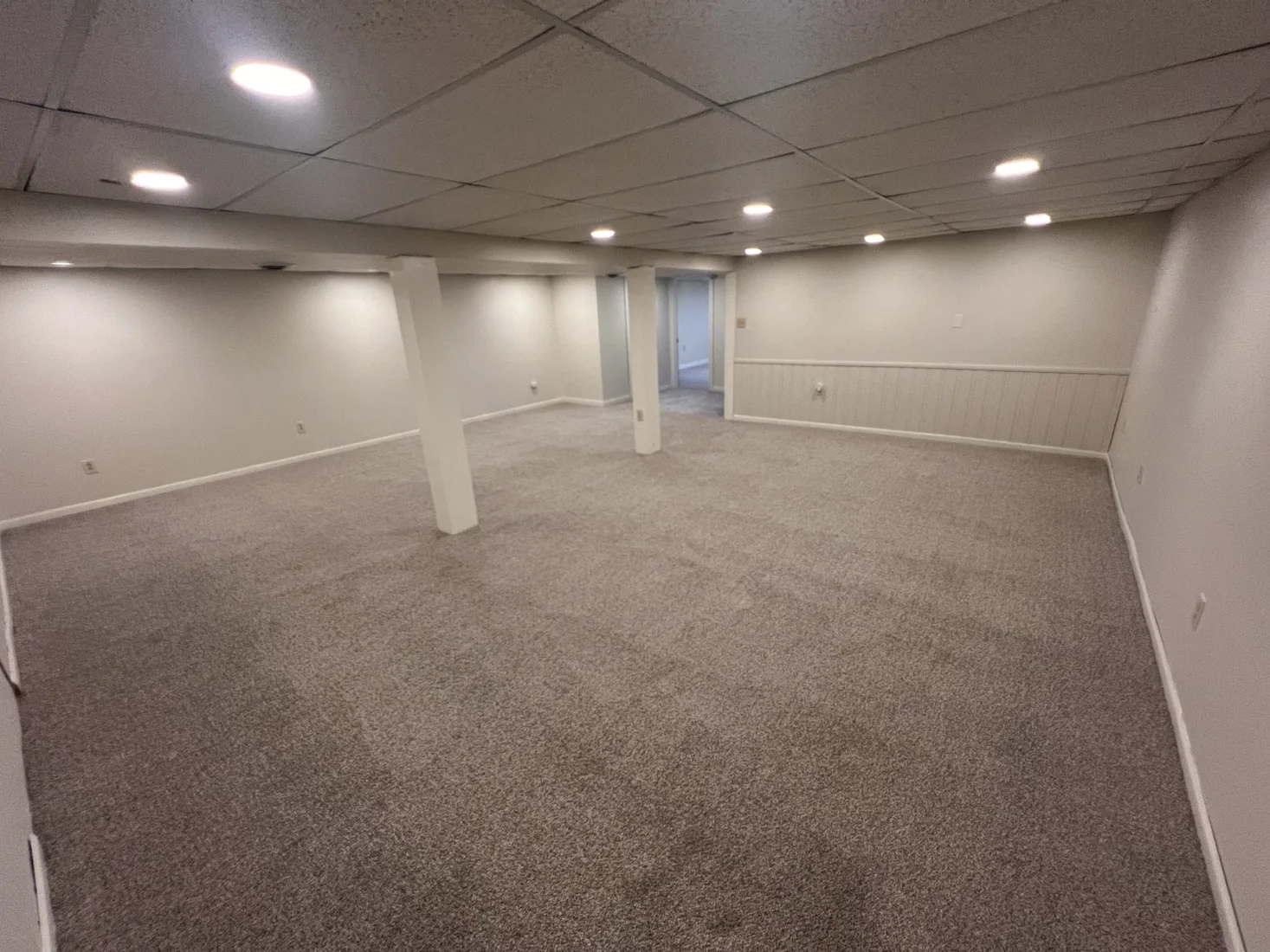 Completed gray basement carpet installation by PrimeLayer Pro Home Service LLC