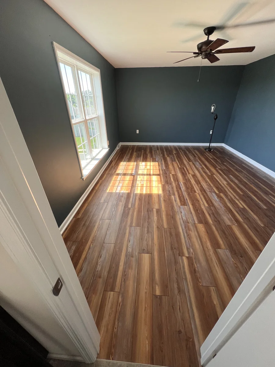 Walnut-look laminate flooring with natural window light